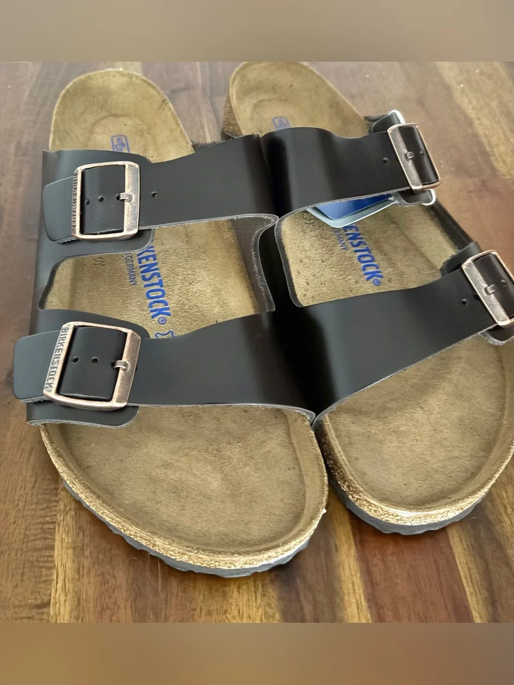 Birkenstock Men’s Arizona Two-Buckle Sandal — Dark Brown with Rose Gold Buckles.